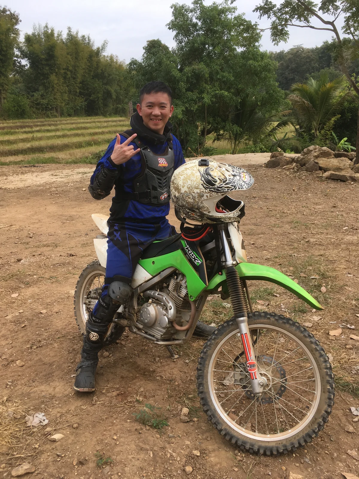 Kevin with a green dirt bike outdoors